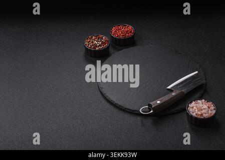 An empty slate cutting board with cutlery on a kitchen counter. Slate cutting board, food background for your design Stock Photo