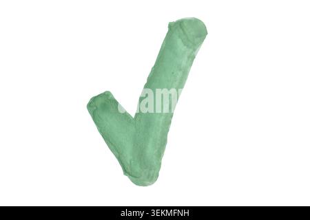 A stroke of green acrylic paint in the shape of a check mark on a white background. Stock Photo