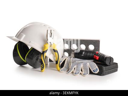 Hardhat, electric screwdriver, pliers and brick isolated on white background Stock Photo
