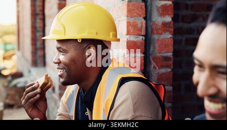 Construction, relax and men with lunch in building for break, rest and happy at renovation site. Engineering, architecture and people with food, laugh Stock Photo