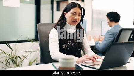 Business, woman and talk with laptop in call centre for research, advice and inquiry for finance. Agent, headset and coworking with pc for customer Stock Photo