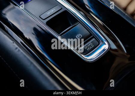 Close Up of Modern Car Electronic Parking Brake and Brake Hold Controls. Electronic Handbrake Switch in Modern Car Interior Stock Photo