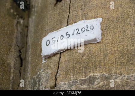 Close-up of a dated plaster patch marking a crack repair on an old stone wall inside Metz Cathedral in Metz, Grand Est, France. Stock Photo