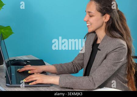 Focused company employee writing commercial email report on computer while sitti Stock Photo