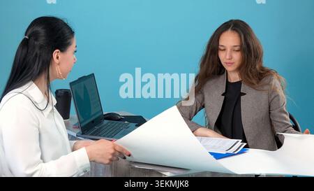 Experienced colleagues brainstorming ideas for construction development on paper Stock Photo