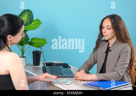 Professional colleagues analyzing blueprint documents and project papers in offi Stock Photo