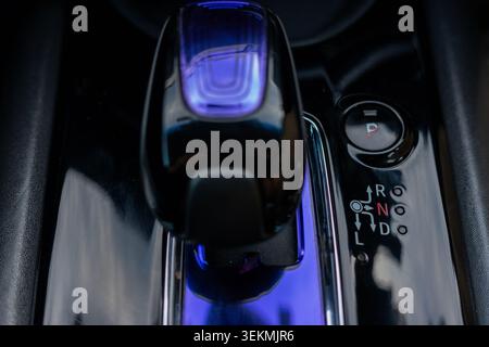 Modern Hybrid Car Futuristic Gear Shifter Lever with Purple LED Ambient Illumination Stock Photo