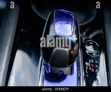 Luxury Car Gear Shifter with Ambient Lighting. Advanced Driving Controls on Vehicle Center Console. Stock Photo