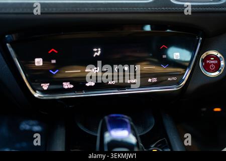 Automotive Digital Climate Control Panel Touchscreen and Red Engine Start Power Button Stock Photo
