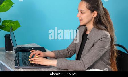 Focused executive employee writing emails or digital business reports on laptop Stock Photo