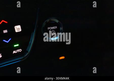 Modern Car Engine Start Stop Power Button with Illuminated Dashboard Stock Photo
