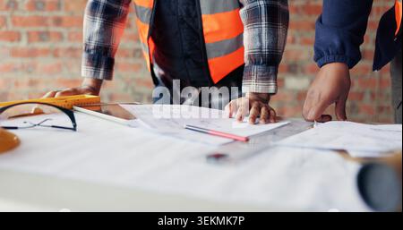 People, hands or architect with blueprint for construction planning, design or building development. Contractor, team or civil engineer with documents Stock Photo