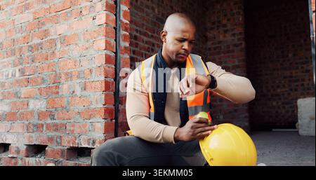 Watch, black man and civil engineer on site with time management for renovation deadline. Professional, building schedule and African male Stock Photo