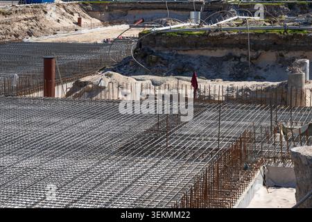 Steel rebar reinforcement grid foundation prepared for concrete slab at large construction site area Stock Photo