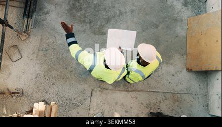 People, architect or pointing with blueprint on construction site above for building design. Top view, contractor or civil engineer with documents Stock Photo