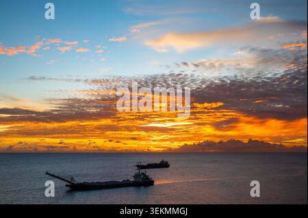 Colorful Ocean Suset with Silhouette of Ships in Antigua and Barbuda, Caribbean Stock Photo