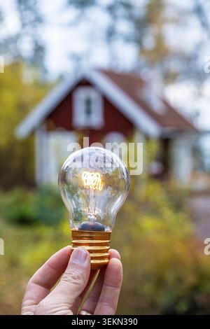 Hand of unrecognizable person holding glowing light bulb Stock Photo