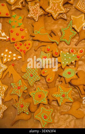 Directly above shot of different shapes of decorated gingerbread baked cookies kept on baking sheet Stock Photo
