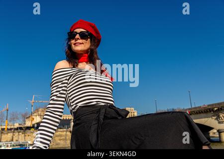 Solo woman traveling in paris expressing joy outdoors Stock Photo
