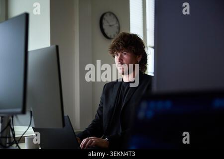 Focused male creative professional working on technologies in tech office Stock Photo