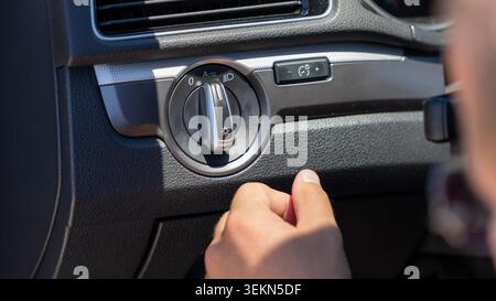 Driver Adjusting Car Headlight Control Switch Close Up Stock Photo