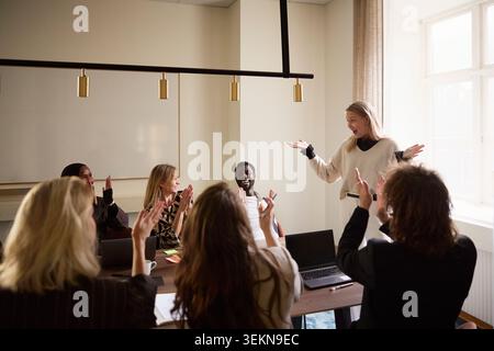 Team of diverse business professionals applauding during meeting at office Stock Photo