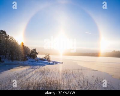 Idyllic scene of solar halo seen at beach during winter Stock Photo