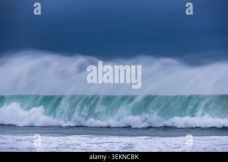 Rolling and crashing waves off Ballycastle Bay on the Causeway Coast, County Antrim, Northern Ireland.  Spring (March) 2026. Stock Photo