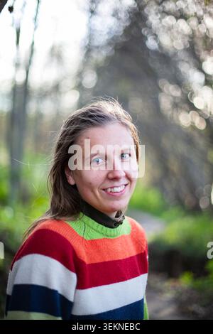 Portrait of smiling woman in striped sweater Stock Photo