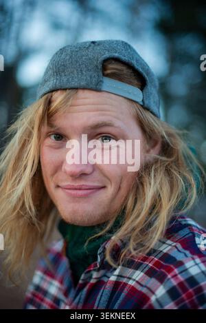 Portrait of man with blond hair wearing cap Stock Photo