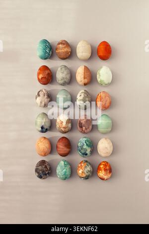 Directly above shot of twenty-four colorful Easter eggs with patterns Stock Photo