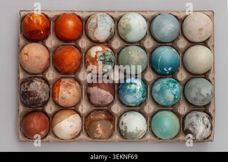 Directly above shot of painted Easter Eggs arranged in tray Stock Photo