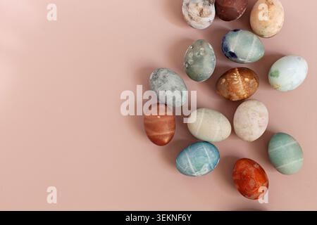 Colorful Easter eggs over beige background Stock Photo