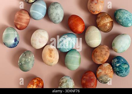 Directly above shot of dyed eggs like stones on beige background Stock Photo