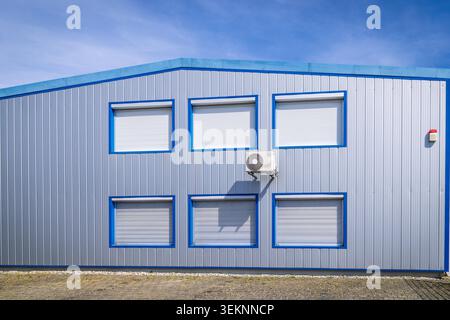 Split pump installed on a wall of industrial building, heating and cooling system Stock Photo