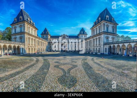 Castle of Valentino with its decorated cobblestone pavement and courtyard on a sunny day with blue sky in Turin, Italy Stock Photo