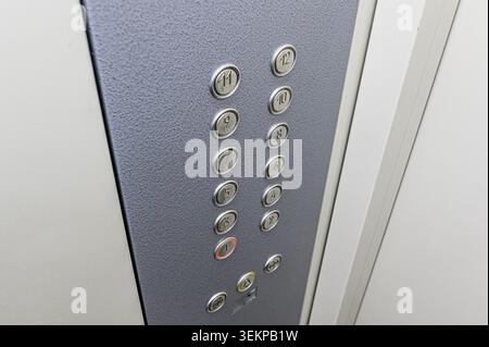 Close-up of an elevator control panel with floor buttons numbered 1-12. Stock Photo
