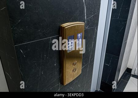 Elevator panel showing floor numbers on a marble wall. Stock Photo