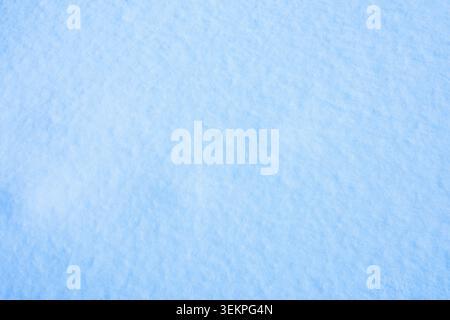 Christmas abstract background. Shiny white snow texture on a winter sunny day. Stock Photo