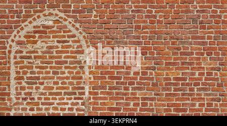 Old brick stone wall with a bricked-up arch Stock Photo