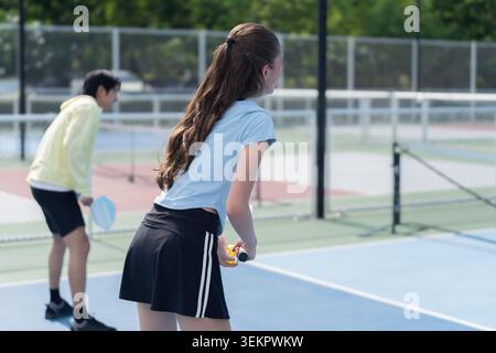 Young Caucasian Woman Playing Pickleball Outdoors Stock Photo