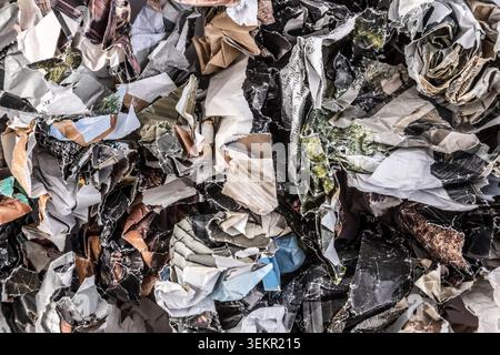 Piles of crumpled paper waste from colorful magazines and newspapers Stock Photo