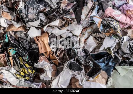 Piles of crumpled paper waste from colorful magazines and newspapers Stock Photo
