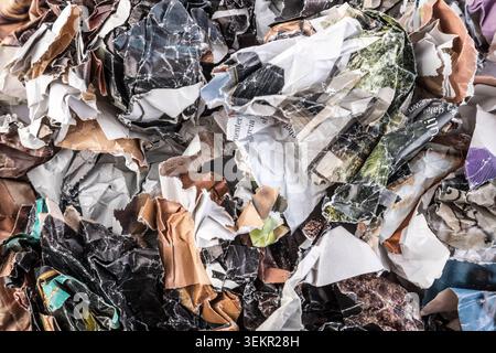 Piles of crumpled paper waste from colorful magazines and newspapers Stock Photo