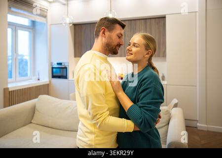 Cheerful man and woman looking at each other and smiling, enjoying bonding in relationships Stock Photo
