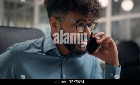 Close up serious Arabian ethnic business man talking mobile phone call businessman confident talk smartphone work negotiation ethnicity male office Stock Photo