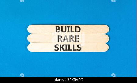 Build rare skills words symbol. Concept words Build rare skills on beautiful wooden sticks. Beautiful blue background. Business and build rare skills Stock Photo