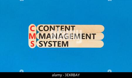 CMS content management system symbol. Concept words CMS content management system on beautiful wooden sticks. Beautiful blue background. Business CMS Stock Photo