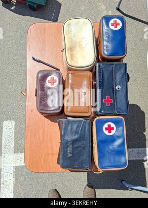 VORONEZH, Russia - April 25, 2026.A collection of vintage Soviet era first aid kits are arranged on a wooden table. Each kit is in a different case, m Stock Photo