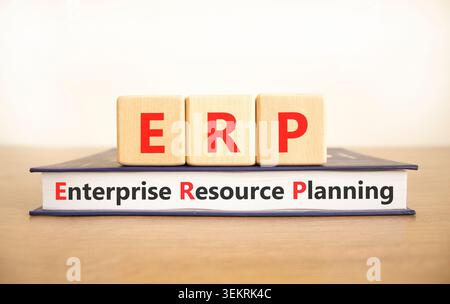 ERP enterprise resource planning symbol. Concept words ERP enterprise resource planning on beautiful wooden blocks and book. Beautiful white backgroun Stock Photo